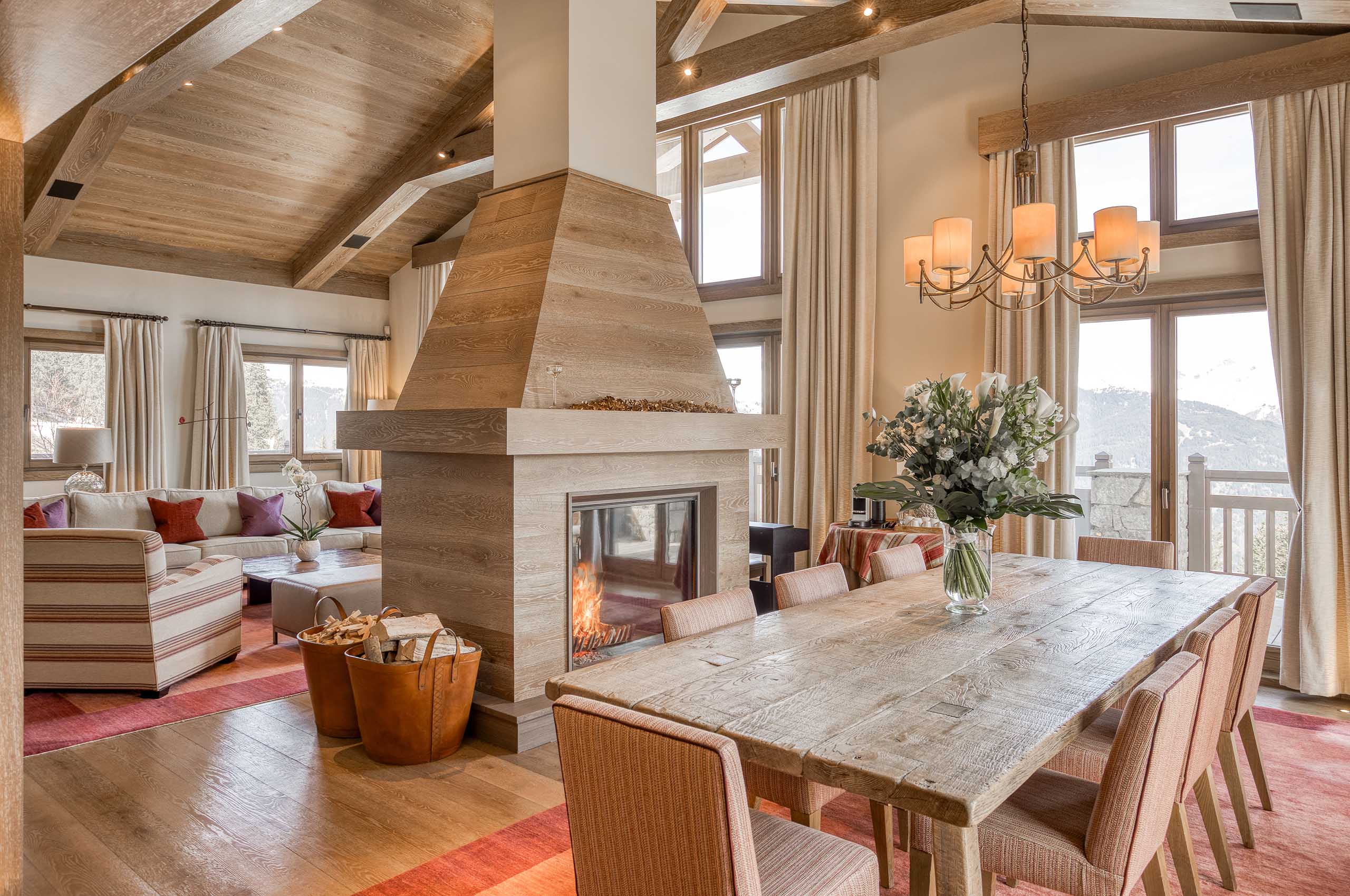 chalet-sheena-fireplace-diningroom-openplan-mountainview-luxury-alpine-interior-courchevel1850