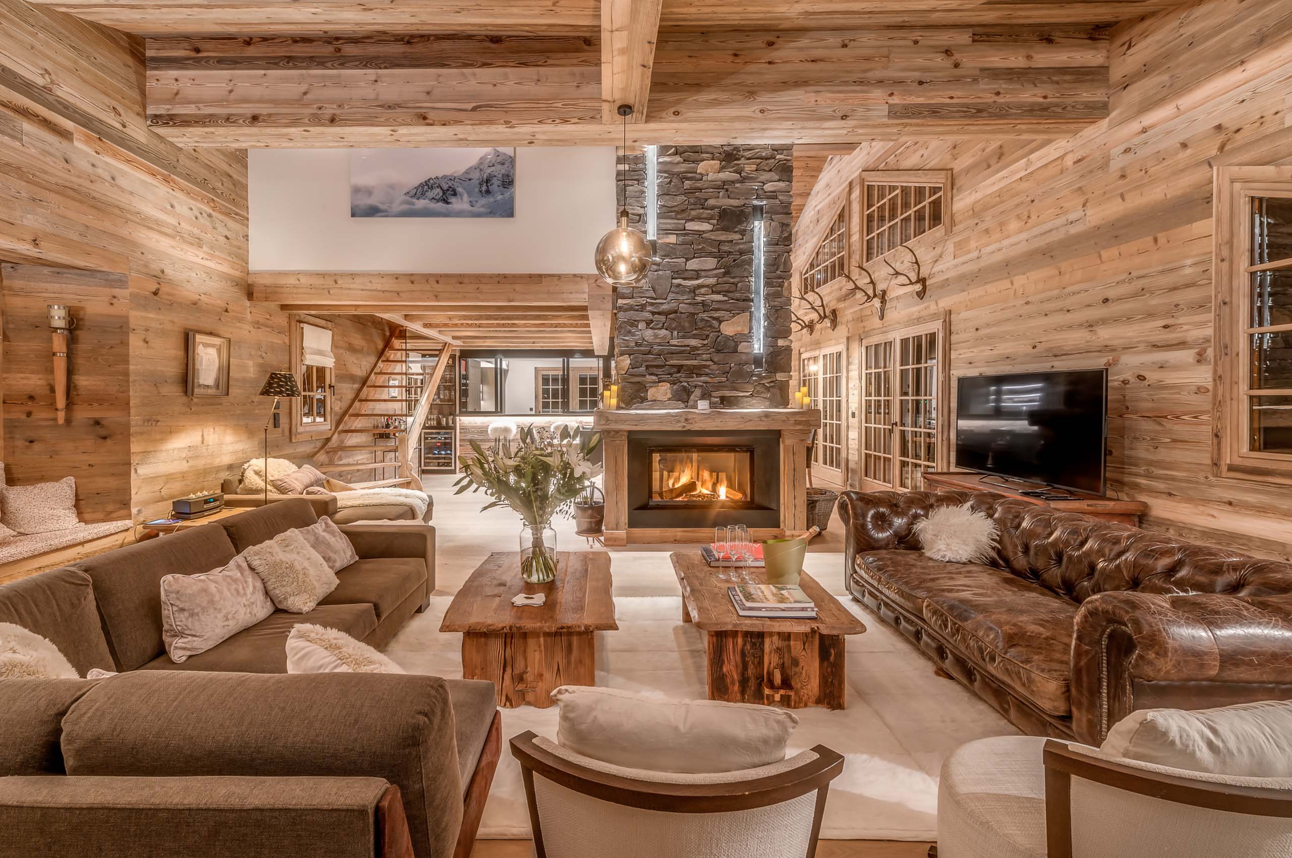 Chalet-nama-mainpage-livingroom-luxury-cosy-alpine-interior-fireplace-courchevel1850