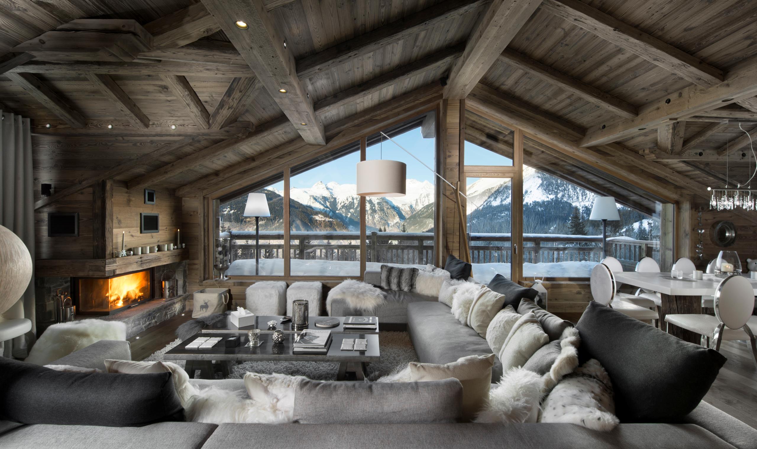 chalet-aure-mainpage-lounge-living-space-mountain-view-balcony-fireplace-grand-elegant-alpine-interiors-luxury-rental-courchevel1550