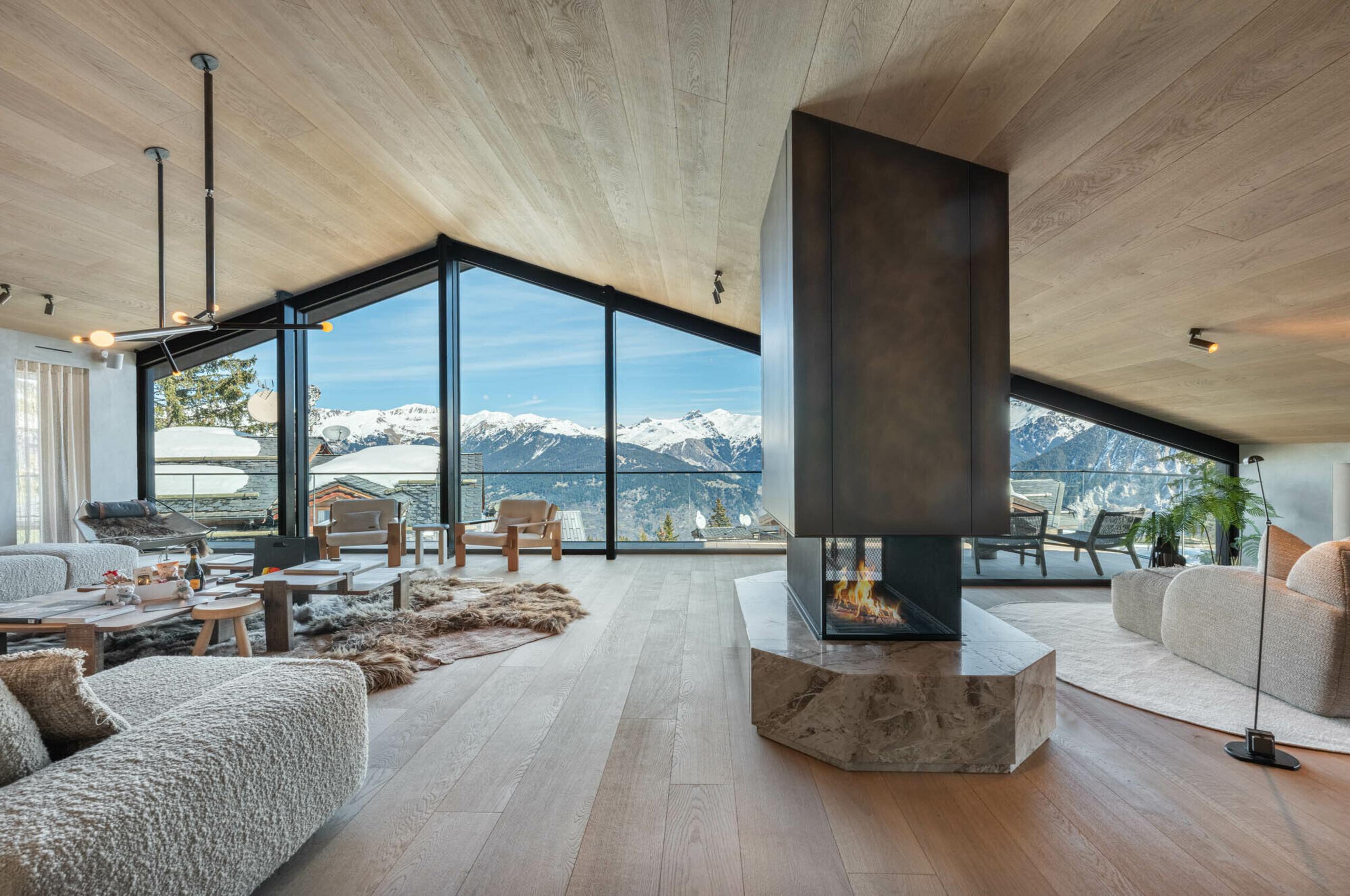 chalet-breeze-livingroom-openplan-mountainview-fireplace-modern-stylish-luxury-interior-courchevel1850
