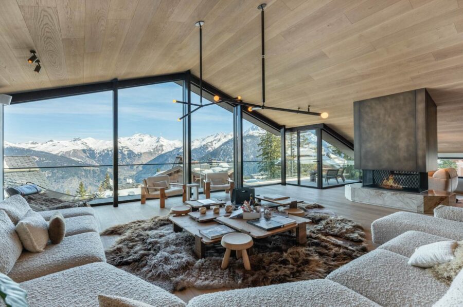 chalet-breeze-mainpage-livingroom-mountainview-fireplace-refined-luxury-furnishings-modern-interior-design-courchevel1850