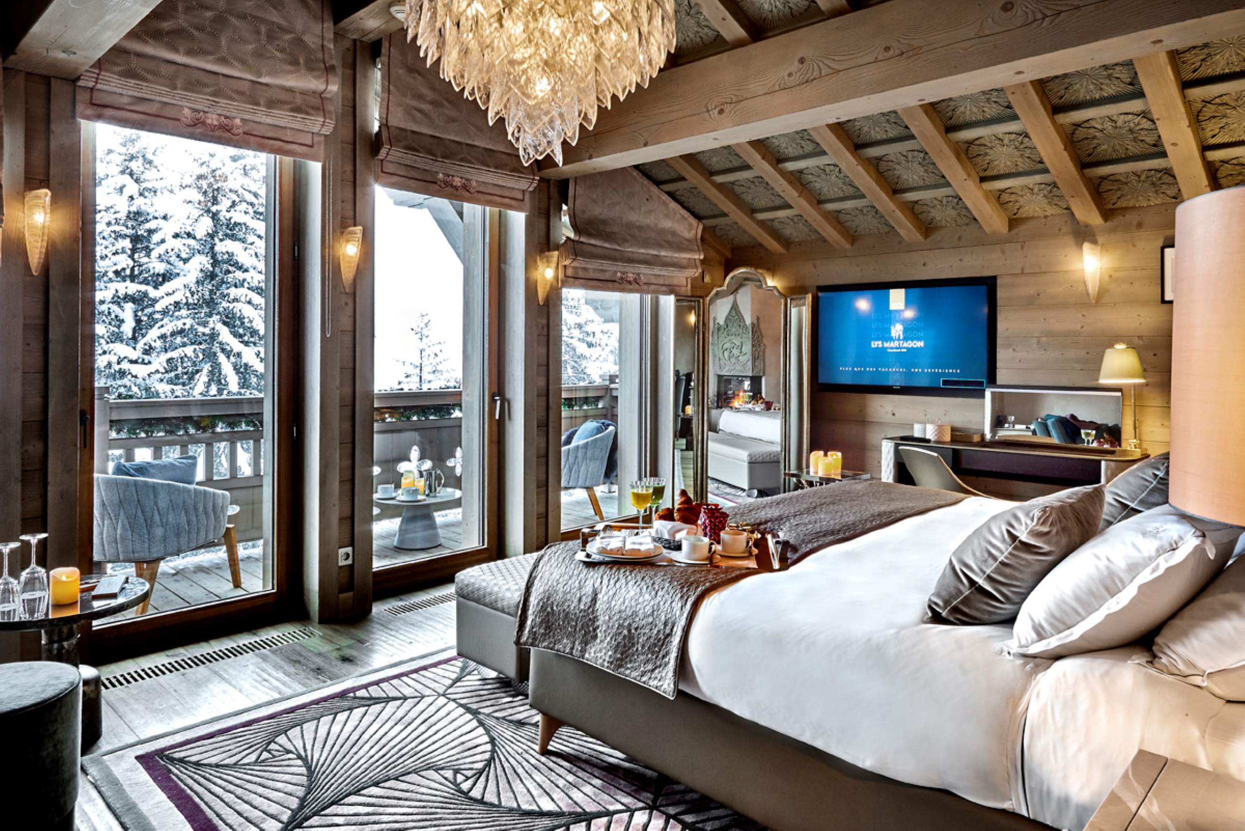 chalet-liza-mainpage-bedroom-balcony-scenic-woodland-views-elegant-alpine-luxury-interiors-megeve