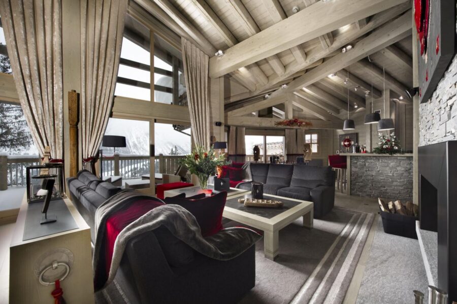 chalet-olympe-mainpage-livingroom-mountainviews-fireplace-spacious-openplan-modern-alpine-design-luxury-courchevel