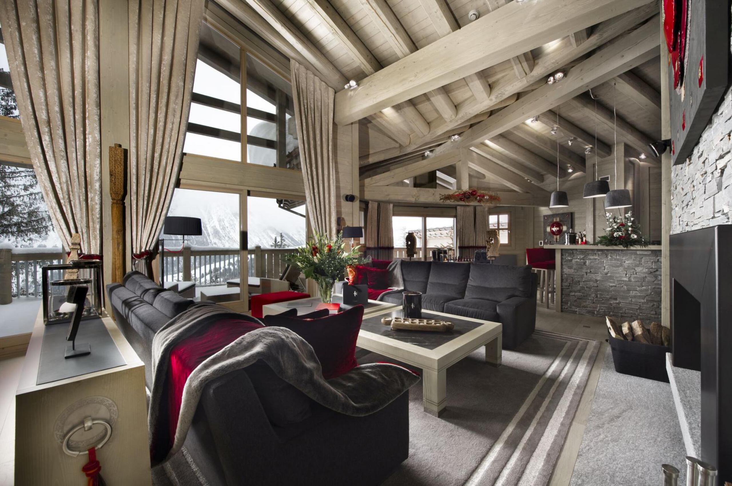 chalet-olympe-mainpage-livingroom-mountainviews-fireplace-spacious-openplan-modern-alpine-design-luxury-courchevel
