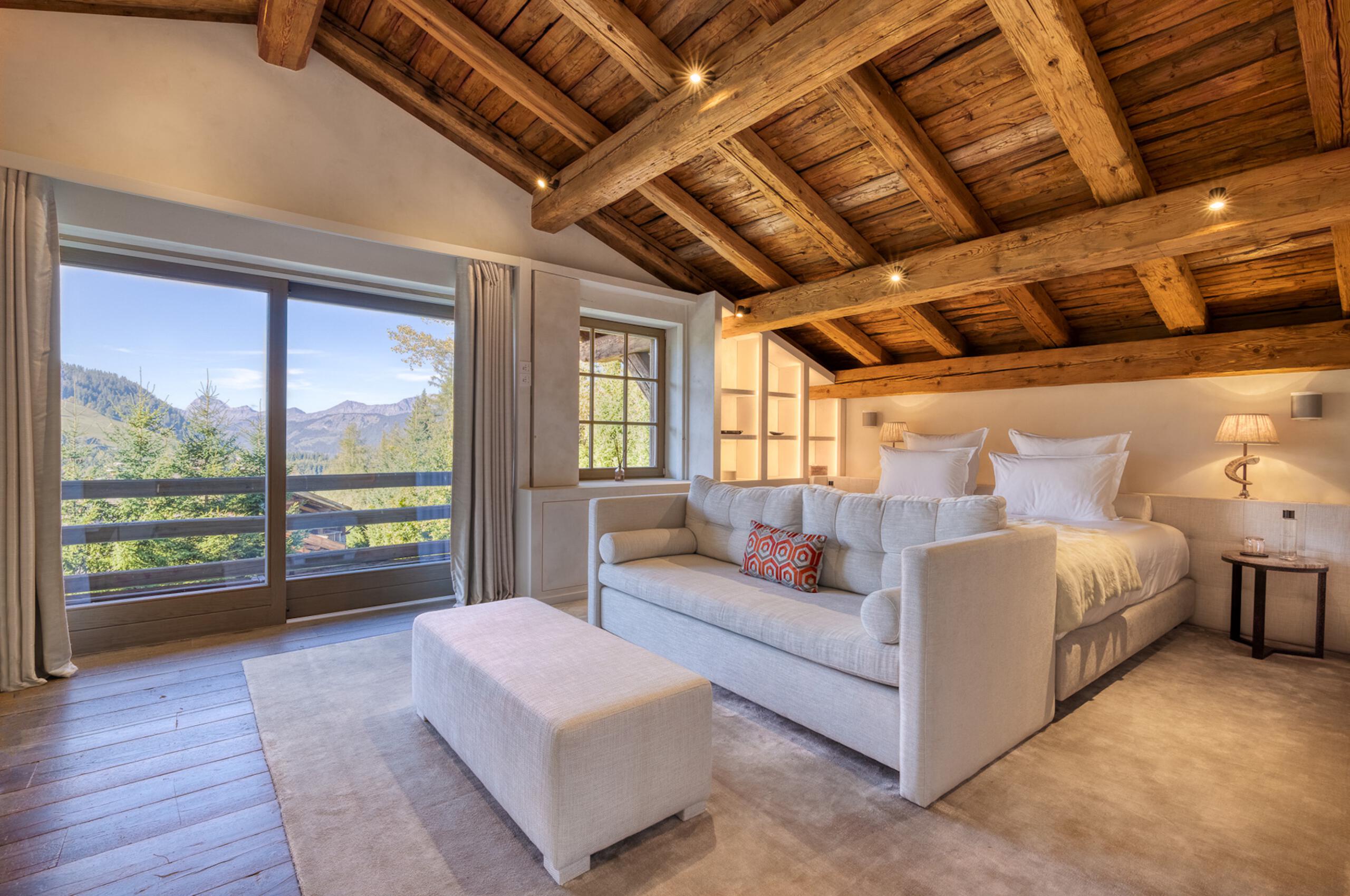 Chalet-Izabelle-bedroom-mountainview-beams-alpine-chic-modern-furnishings-luxury-rental-retreat-megeve
