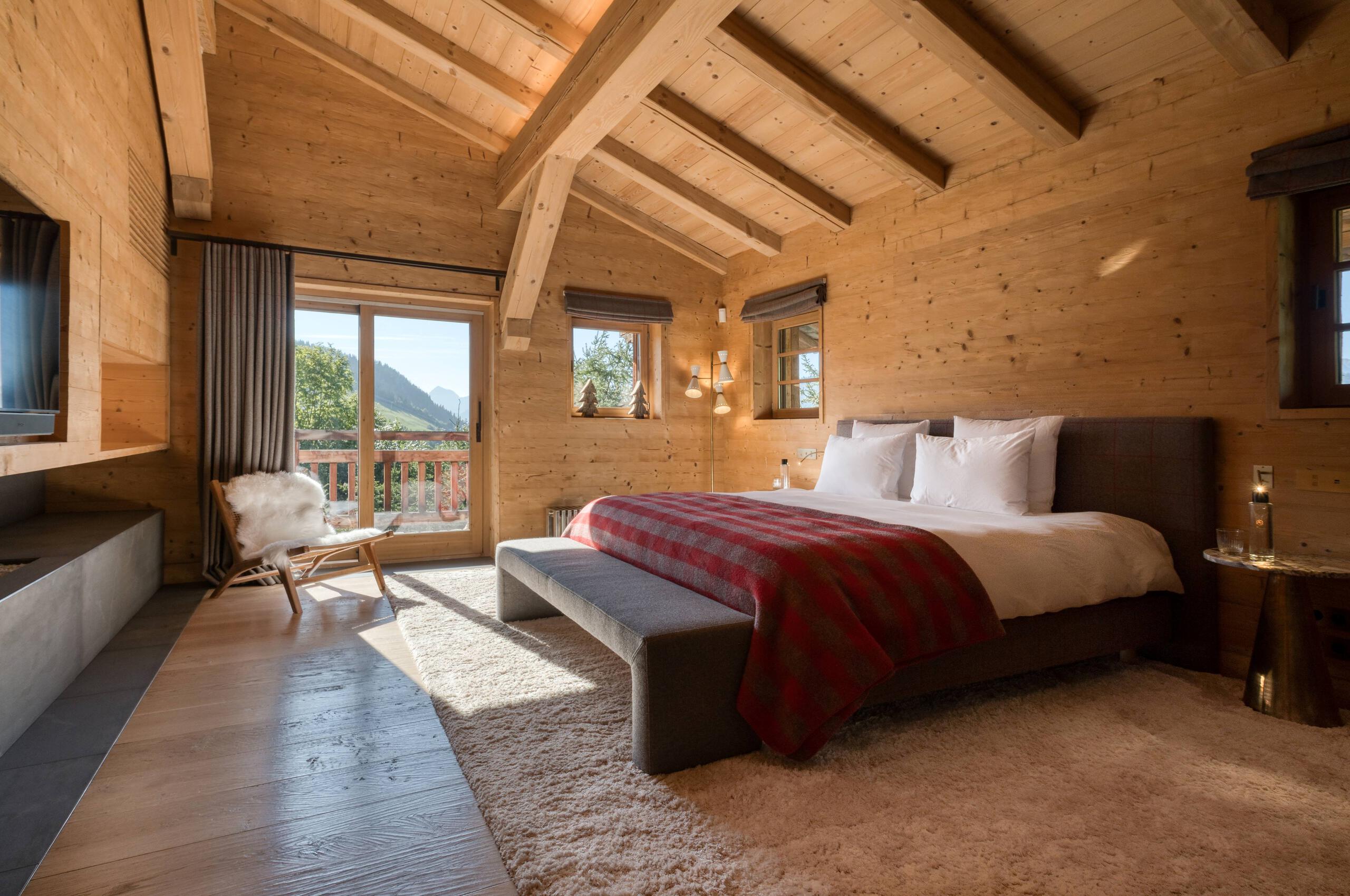 Chalet-atina-bedroom-balcony-tv-fireplace-modern-spacious-alpine-design-luxury-retreat-megeve-mont-d'arbois