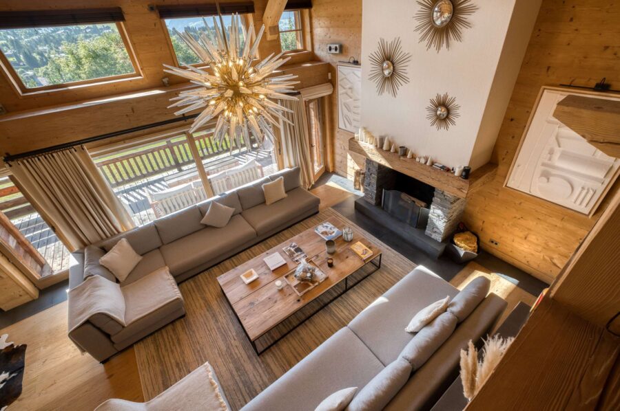 Chalet-atina-livingroom-fireplace-highceiling-openplan-luxury-elegant-interiordesign-megeve-mont-d'arbois