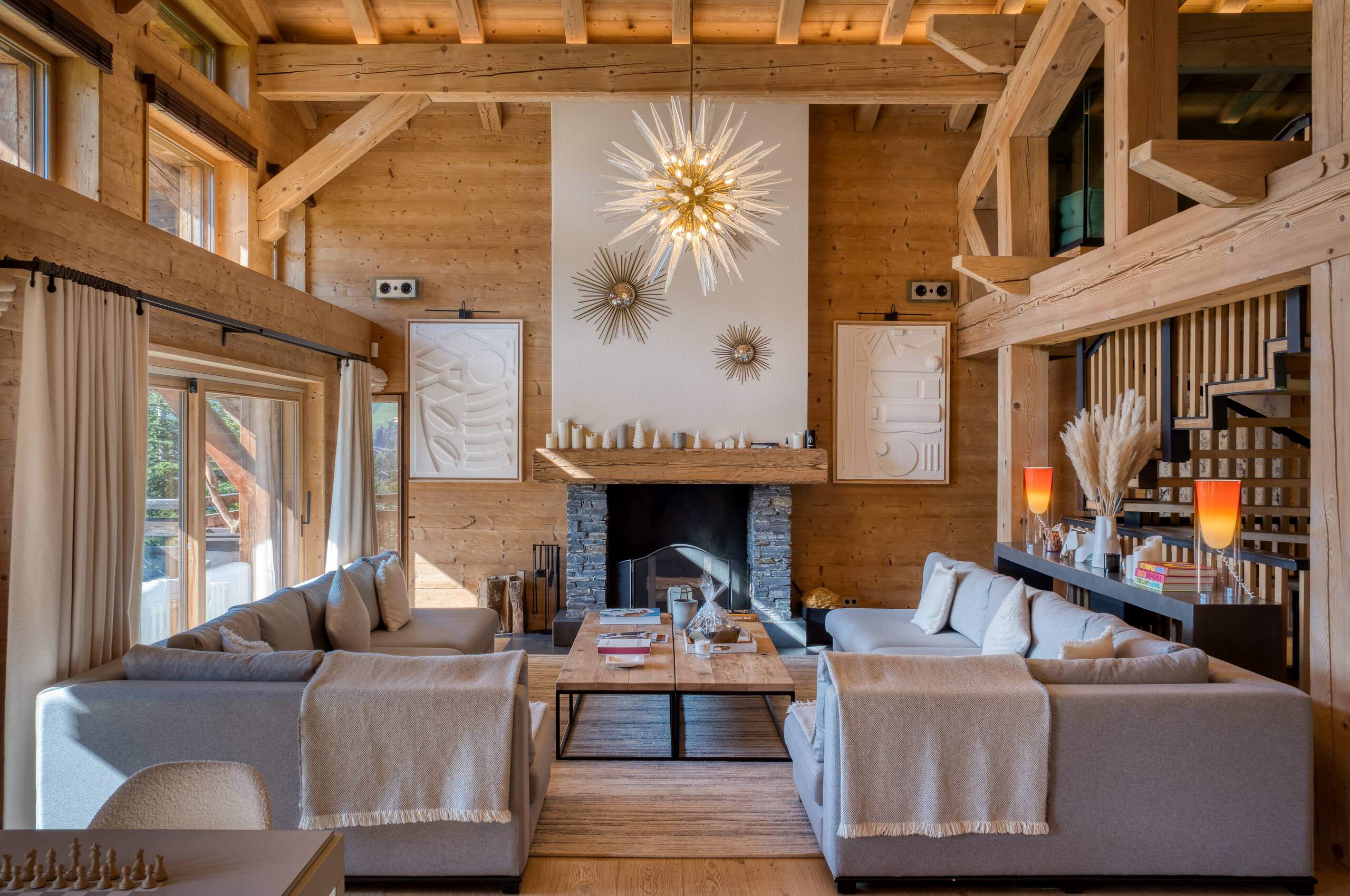 Chalet-atina-livingroom-fireplace-openplan-elegant-modern-alpine-design-luxury-rental-property-megeve-mont-d'arbois