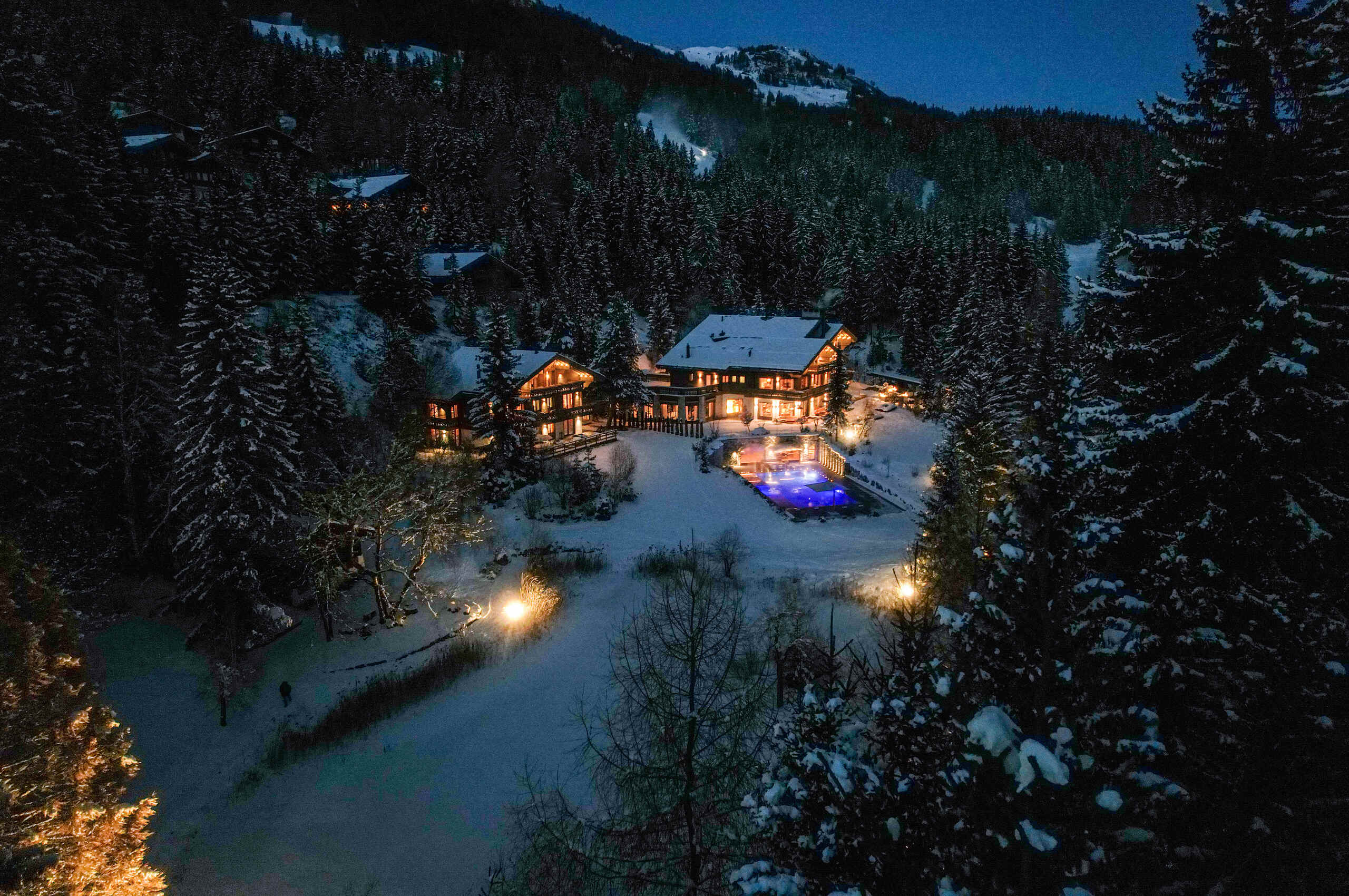 chalet-criselda-exterior-night-cosy-luxury-retreat-snowy-escape-crans-montana