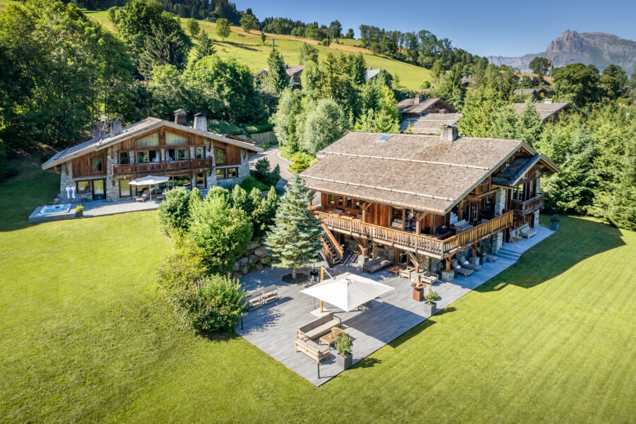 chalet-deuce-exterior-summer-daytime-lush-green-garden-outdoor-seating-luxury-rental-retreat-megeve