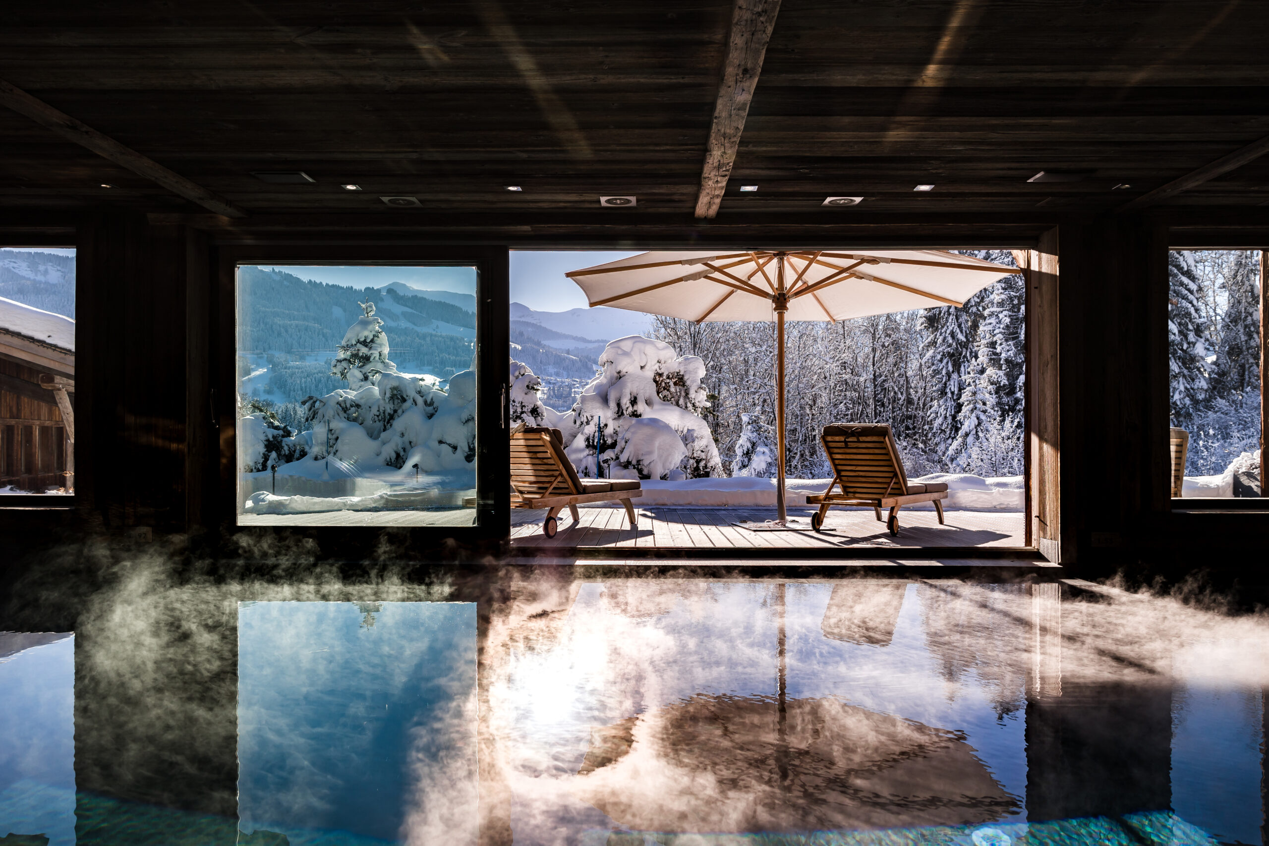 chalet-deuce-indoorpool-winter-terrace-snowy-mountainview-luxury-rental-retreat-wellness-relaxation-megeve