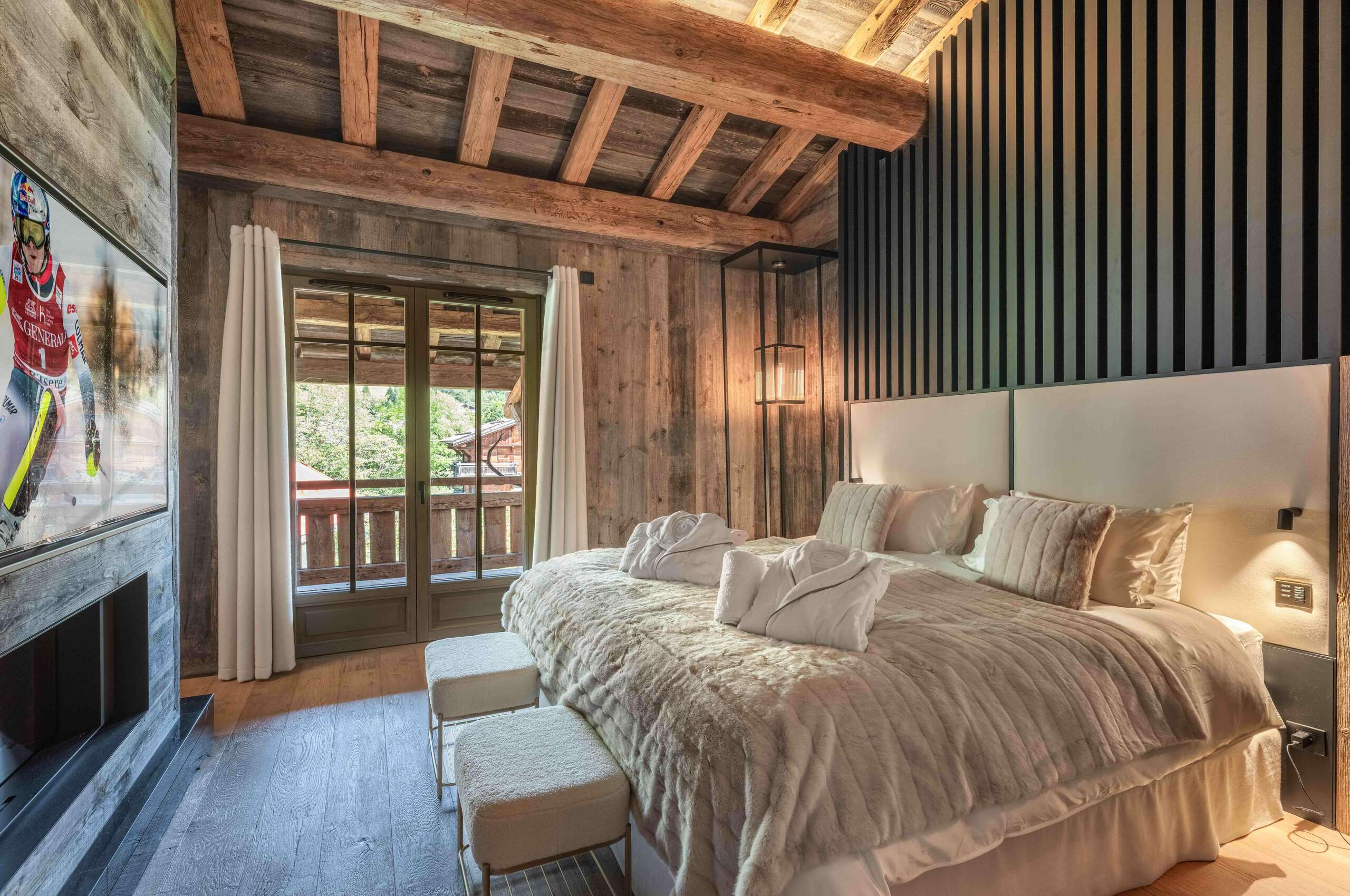 chalet-leia-bedroom-balcony-tv-fireplace-beams-modern-alpine-interior-design-luxury-furnishings-megeve
