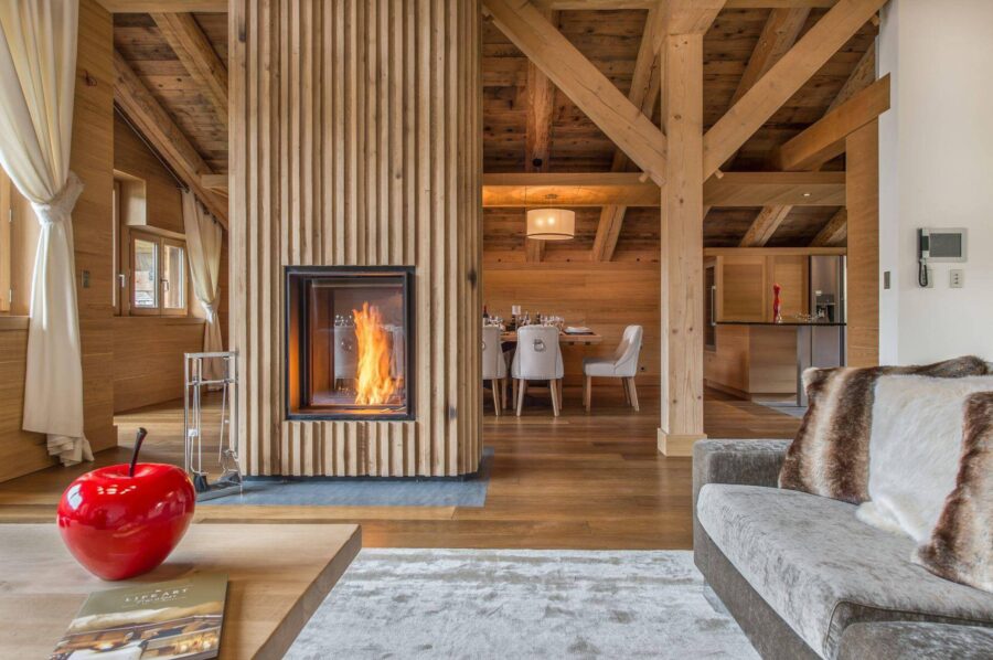chalet-malorie-livingroom-diningroom-openplan-fireplace-modern-elegant-alpine-design-luxury-megeve
