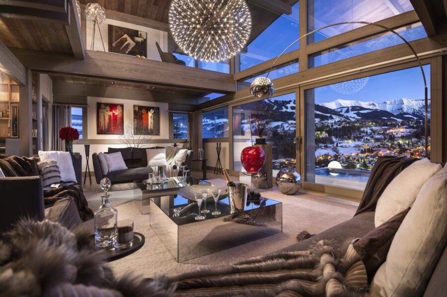 chalet-marianne-mainpage-lounge-livingroom-stunning-mountain-views-heigh-ceilings-grand-stylish-elegant-interiordesign-luxury-megeve