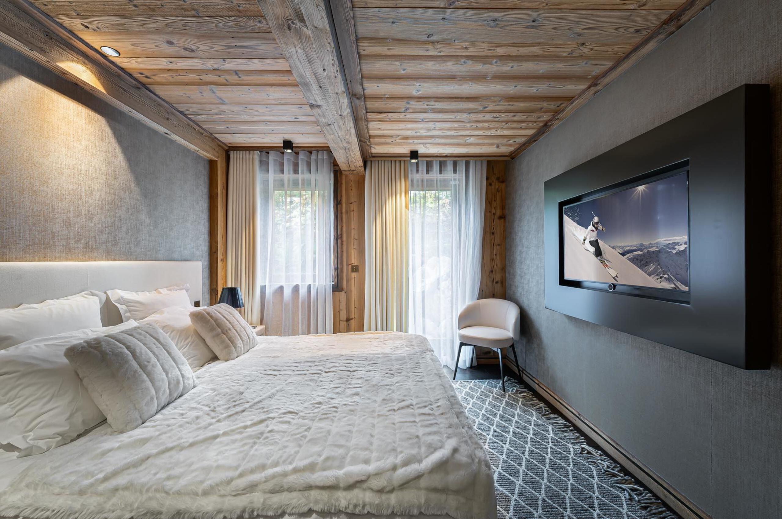chalet-olga-bedroom-tv-wooden-beams-luxury-modern-alpine-design-megeve