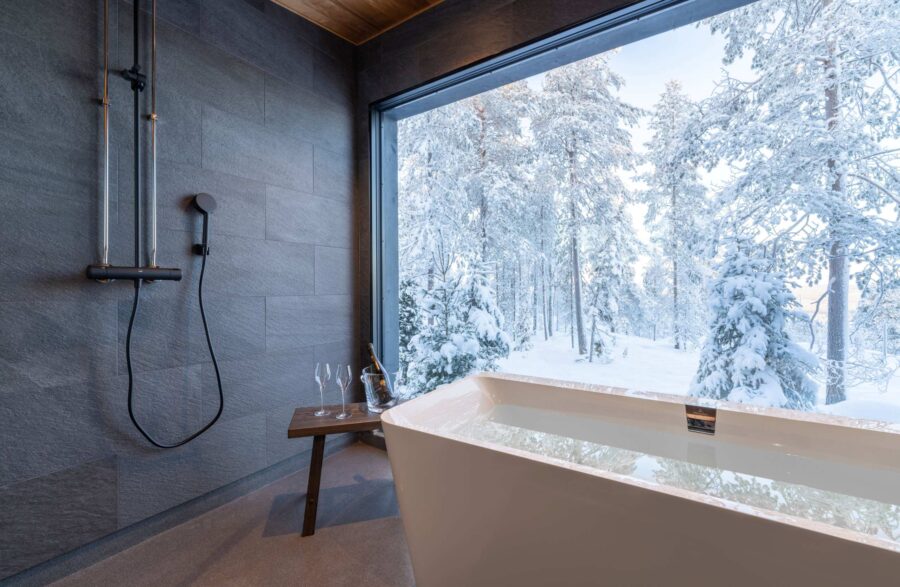 residence-indigo-bathtub-bathroom-scenic-winter-woodland-views-sleek-modern-luxury-design-lapland