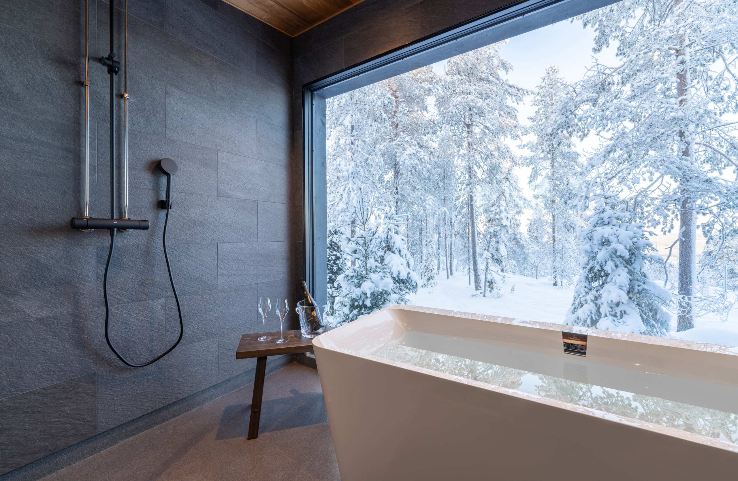 residence-indigo-bathtub-bathroom-scenic-winter-woodland-views-sleek-modern-luxury-design-lapland