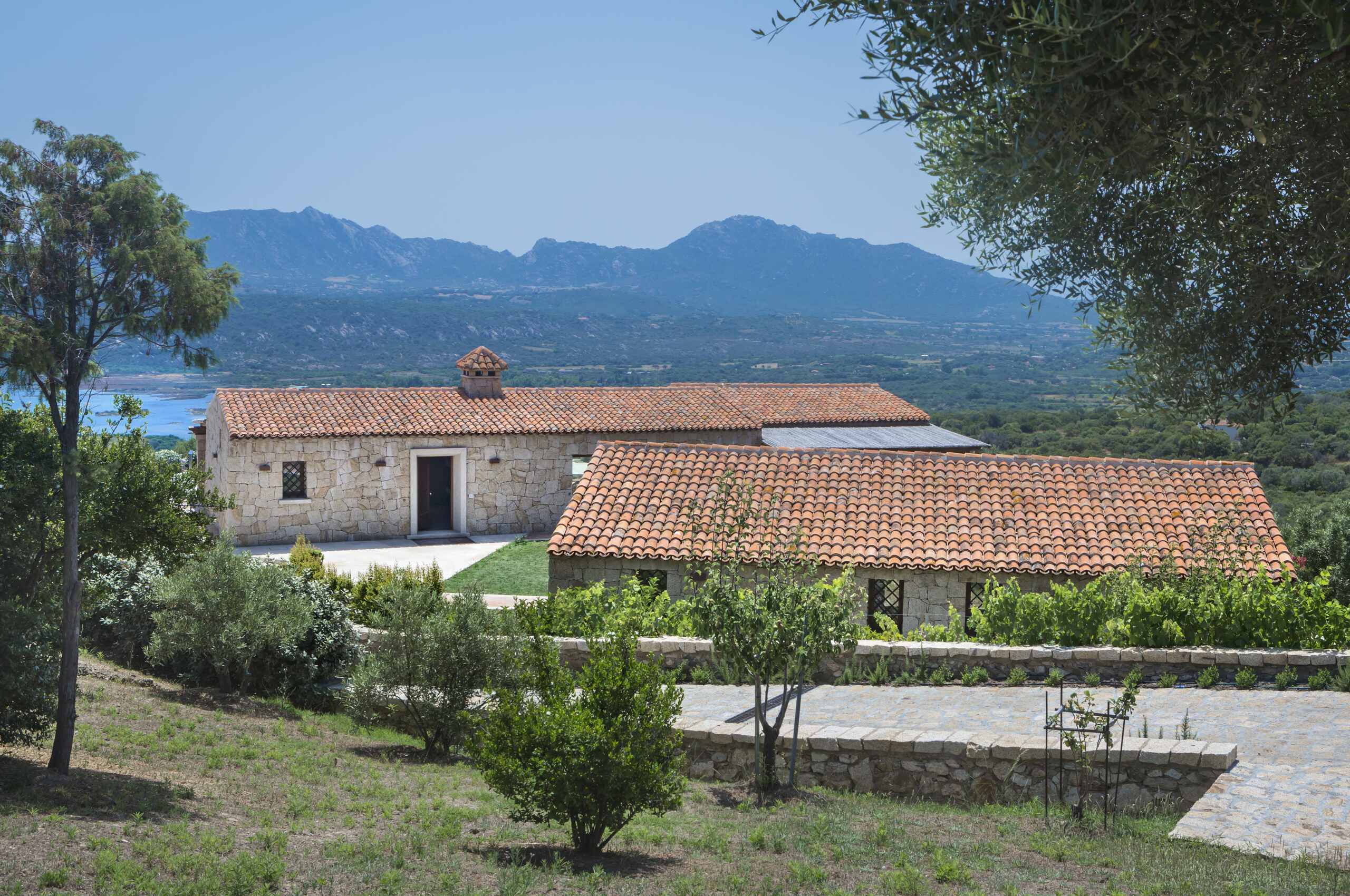 villa-callen-exterior-garden-driveway-scenic-mountain-landscape-seaview-luxury-traditional-rental-property-sardinia