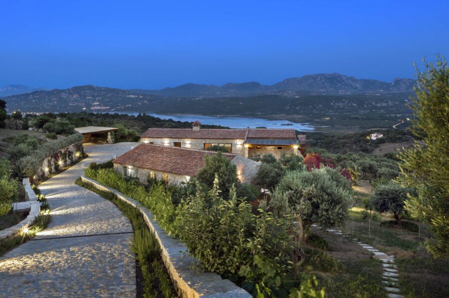 villa-callen-mainpage-exterior-night-driveway-paradise-garden-stunning-sea-mountain-landscape-luxury-rental-retreat-sardinia