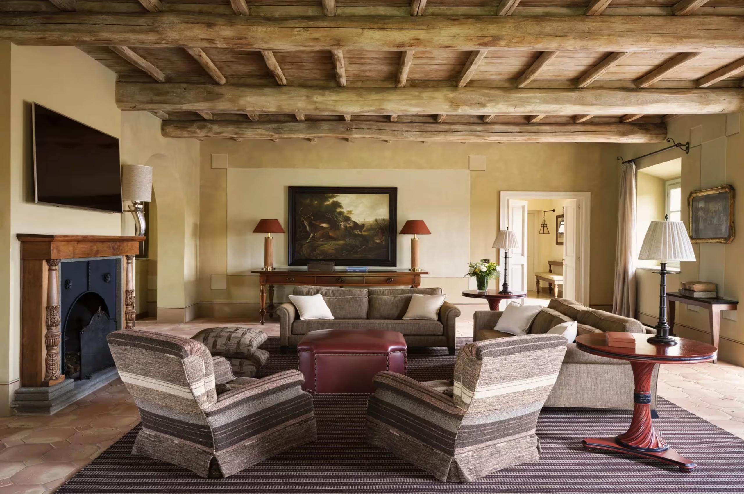 villa-iris-living-room-fireplace-wood-beamed-ceilings-elegant-traditional-design-luxury-tuscany