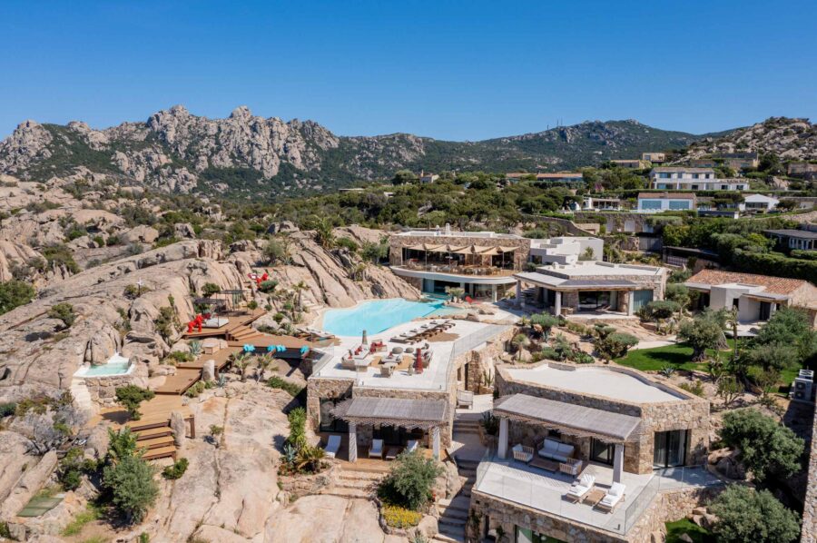 villa-miliania-mainpage-exterior-large-unqiue-mountain-rock-retreat-bespoke-architecture-stylish-modern-luxury-rental-property-sardinia