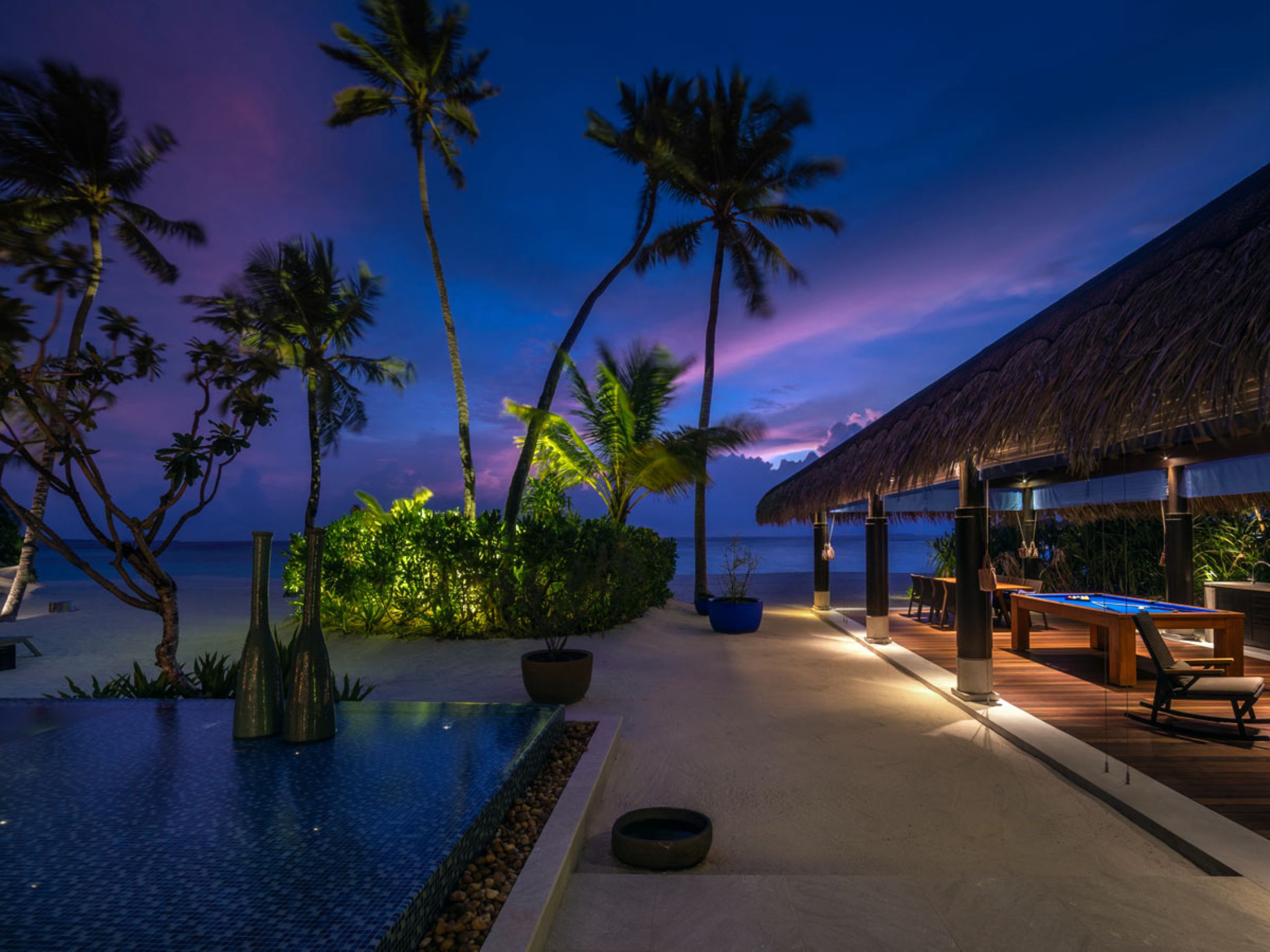villa-vee-exterior-night-pool-games-outdoor-dining-seaview-luxury-rental-maldives