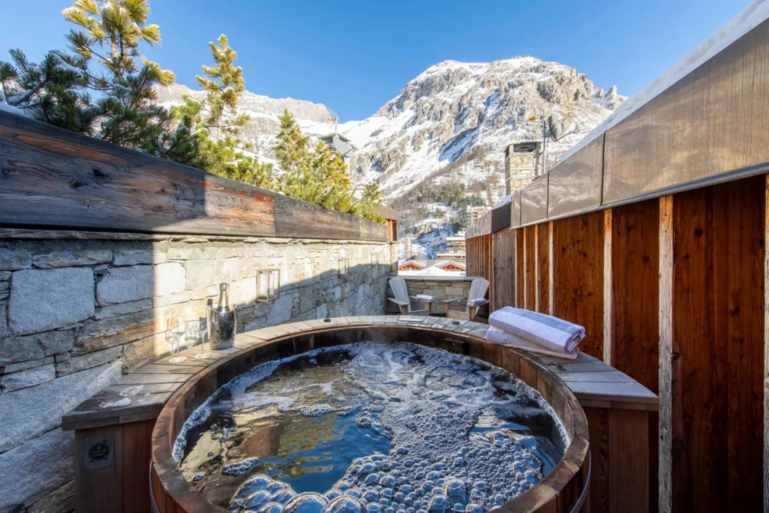 chalet-eva-hot-tub-jacuzzi-mountain-view-exterior-daytime-luxury-alpine-rental-retreat-vald'isere