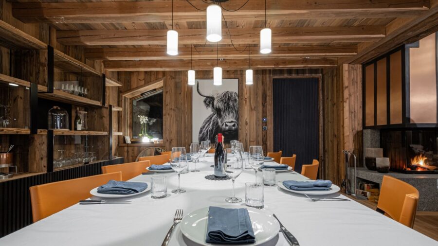 chalet-orly-dining-room-artwork-fireplace-elegant-modern-alpine-interiors-luxury-vald'isere