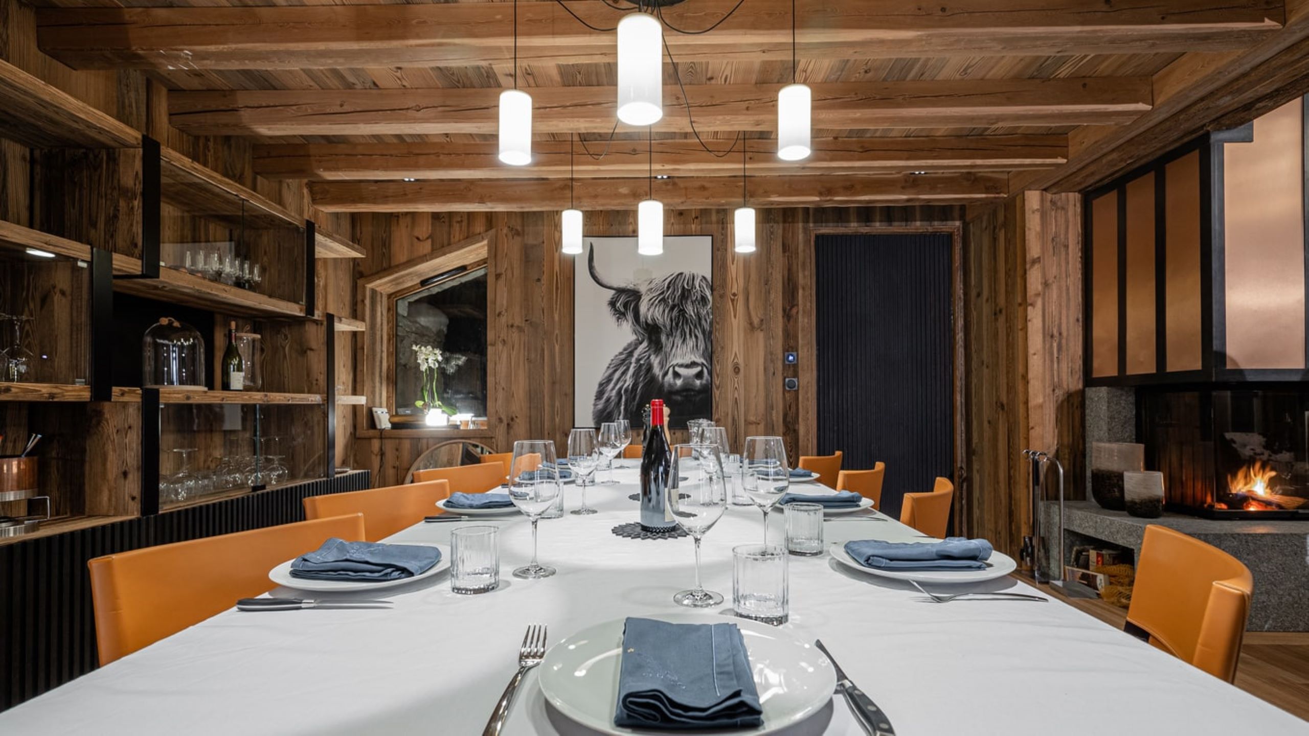 chalet-orly-dining-room-artwork-fireplace-elegant-modern-alpine-interiors-luxury-vald'isere