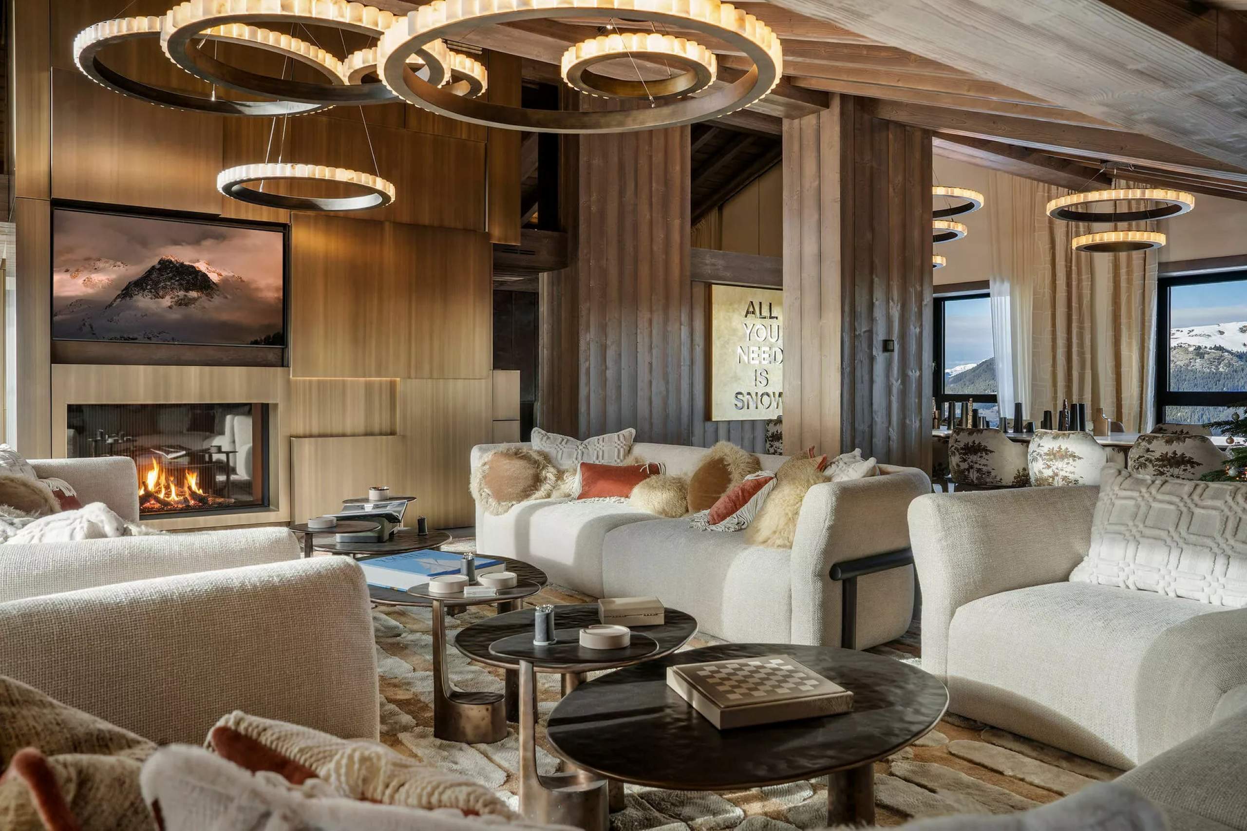residence-air-mainpage-livingroom-fireplace-diningroom-mountain-views-sleek-modern-spacious-design-luxury-courchevel1850