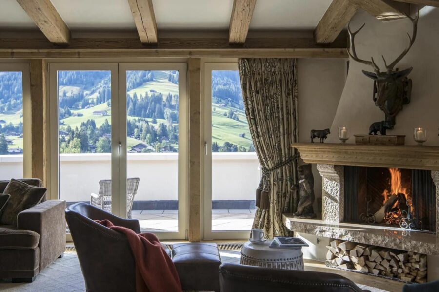 residence-grace-living-room-lounge-fireplace-scenic-alpine-views-terrace-luxury-cosy-gstaad