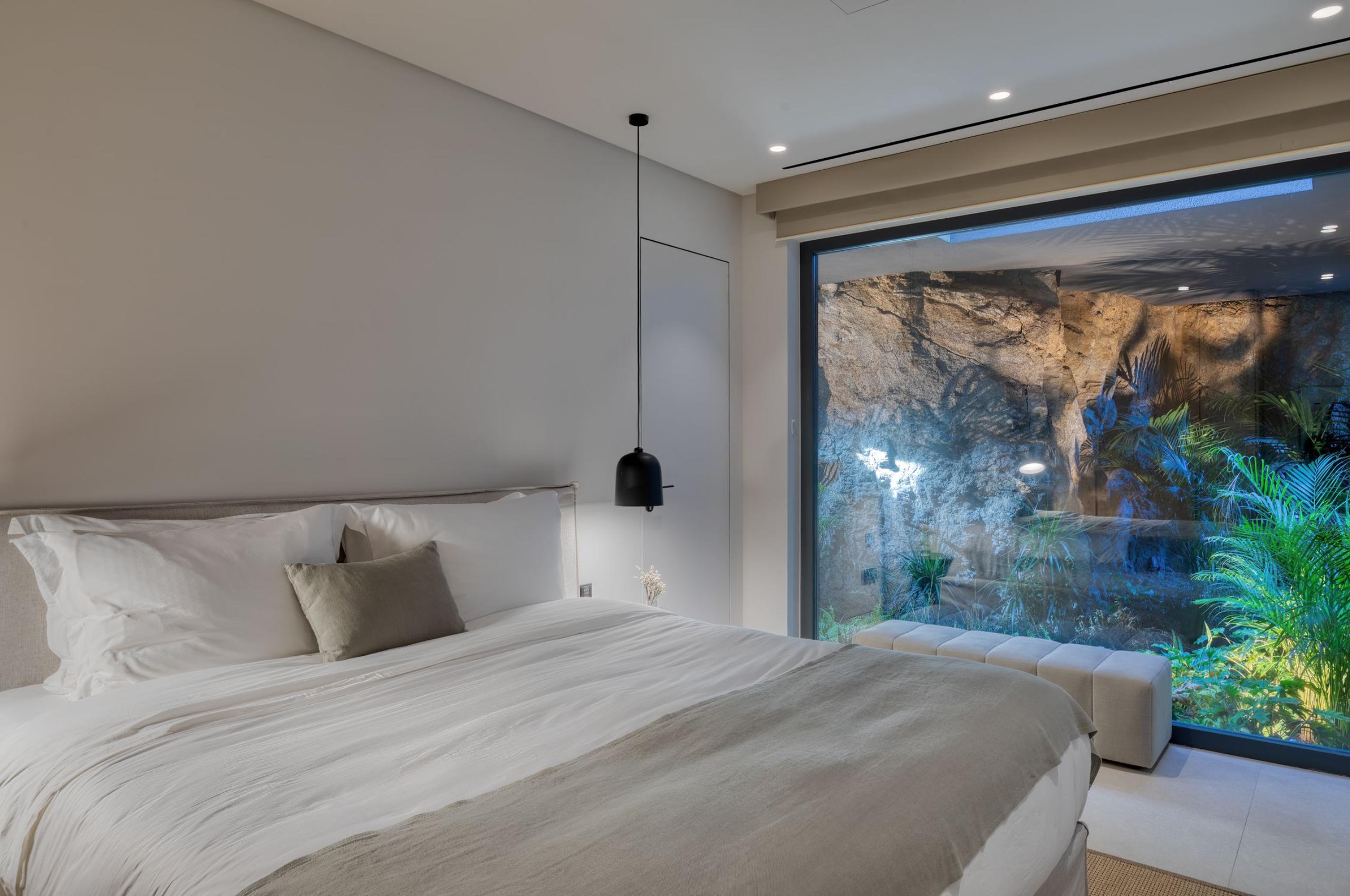 villa-august-bedroom-unique-rock-plant-display-luxury-interiors-mykonos