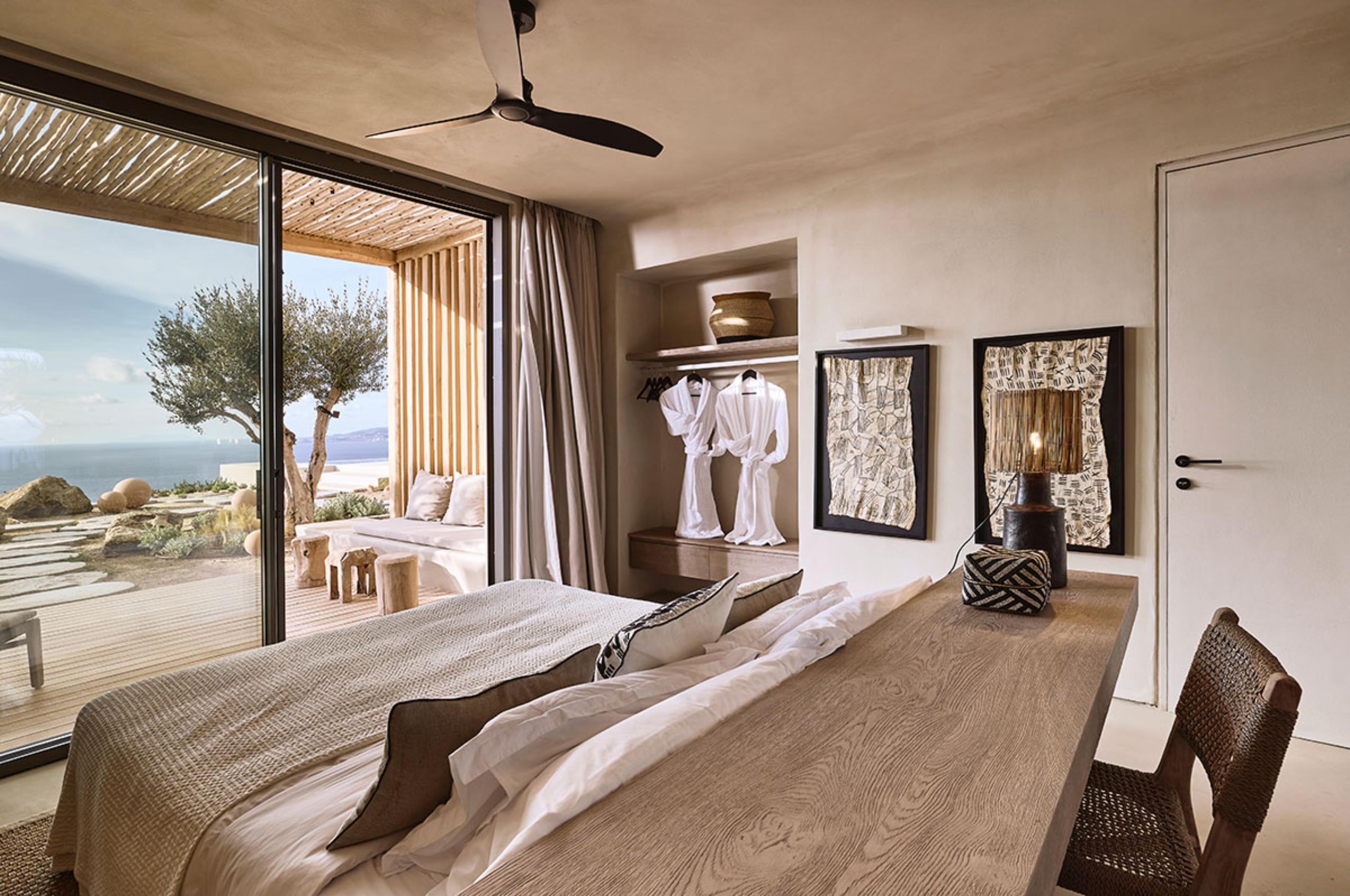 villa-daphne-bedroom-sea-view-terrace-access-wardrobe-artwork-stylish-design-luxury-mykonos