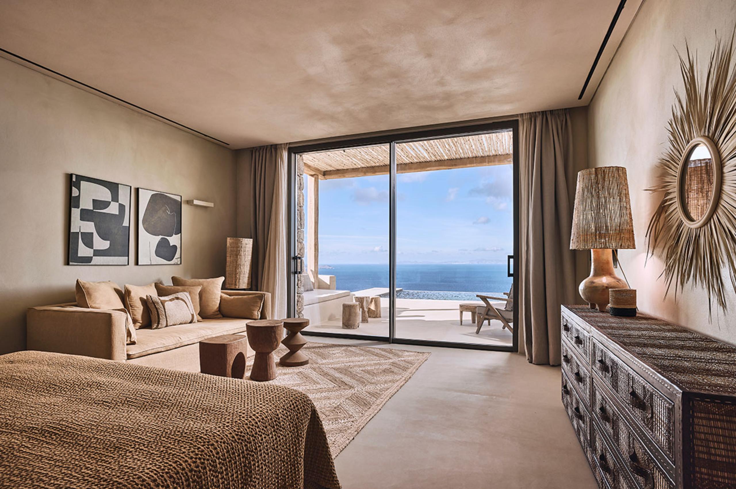 villa-daphne-bedroom-sea-views-sofa-artwork-terrace-access-luxury-mykonos