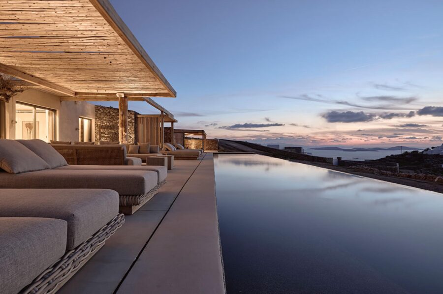 villa-daphne-infinity-swimming-pool-night-exterior-sunloungers-sea-view-luxury-mykonos