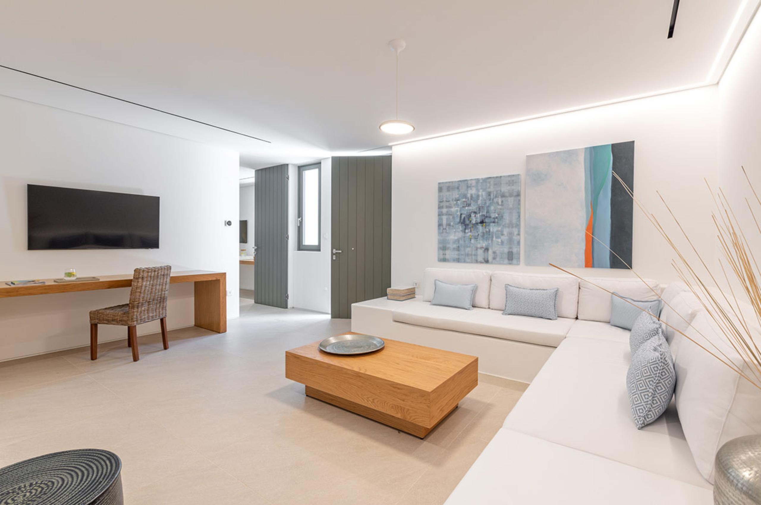 villa-diana-bedroom-living-area-desk-tv-artwork-modern-serene-design-luxury-mykonos
