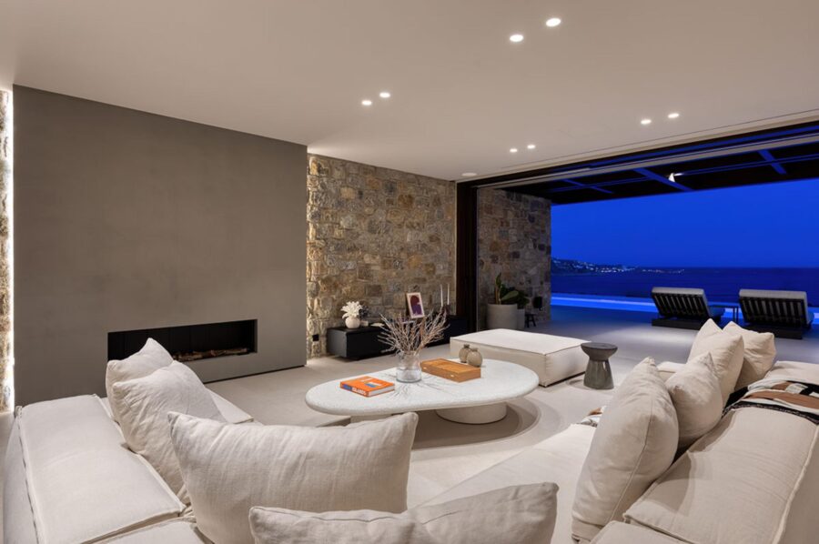 villa-lyra-living-room-fireplace-modern-design-terrace-access-openplan-sea-view-luxury-mykonos