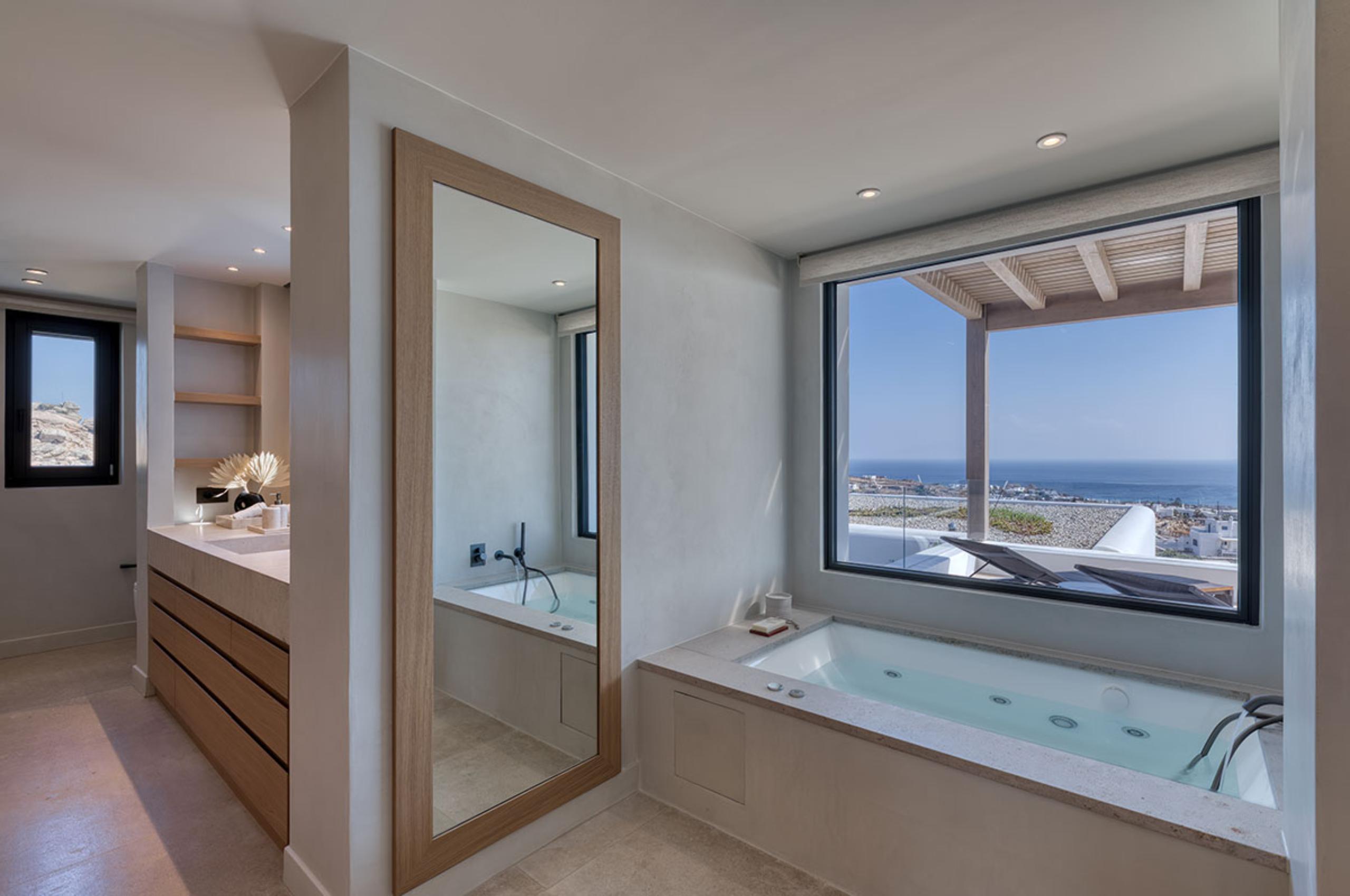 villa-petra-bathroom-jacuzzi-bathtub-sink-scenic-sea-views-modern-luxury-mykonos