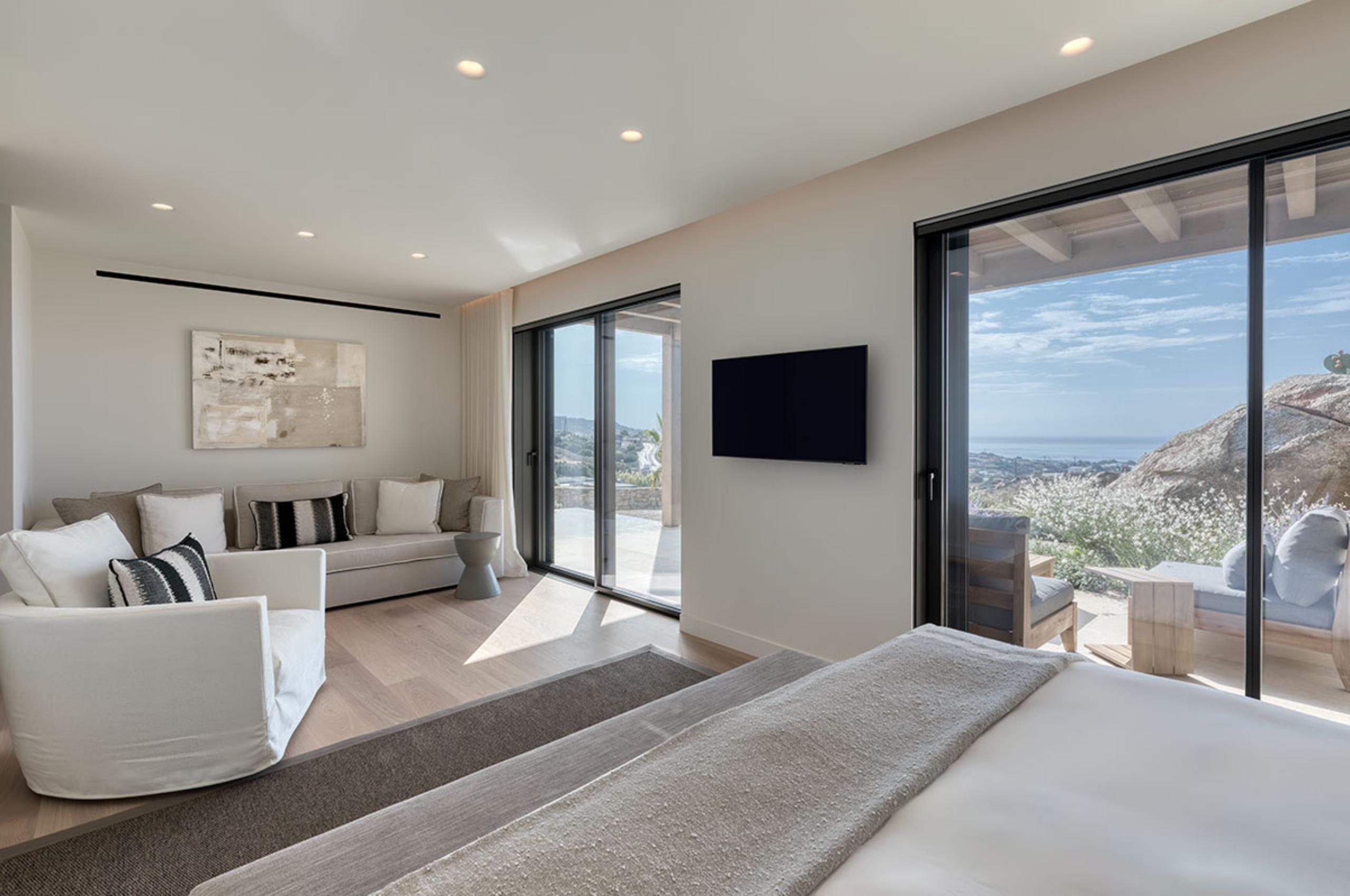 villa-petra-bedroom-lounge-area-tv-serene-modern-design-scenic-sea-views-luxury-mykonos