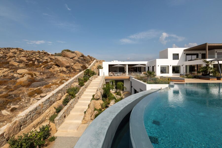 villa-petra-exterior-infinity-swimming-pool-garden-path-terrace-natural-surroundings-luxury-mykonos