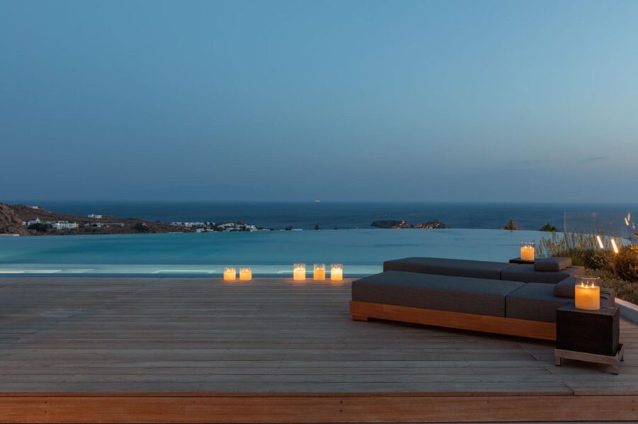 villa-petra-terrace-infinity-swimming-pool-night-candelit-sunbeds-scenic-sea-views-luxury-mykonos