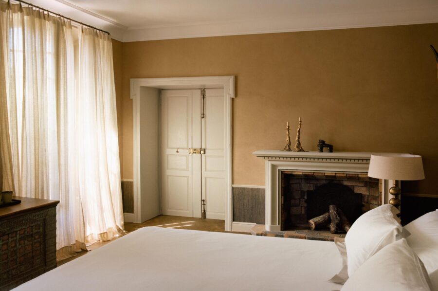 villa-suzanne-bedroom-fireplace-elegant-interior-design-luxury-provence